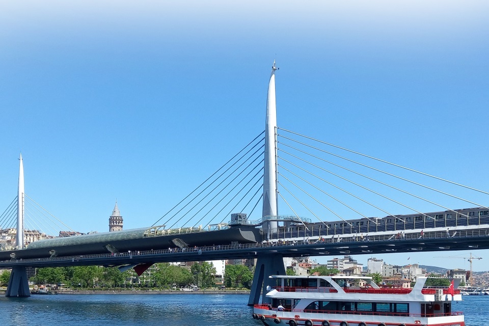 Guided tour boat cruising on the Bosphorus with a view of the Golden Horn Bridge