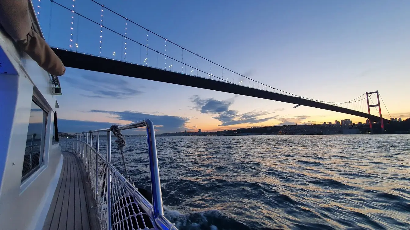 A Bosphorus Cruise for Corporate Events with a yacht cruising in Istanbul at sunset.