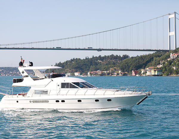 Tavern cruise ship  on Bosphorus sailing near Istanbul with a bridge in the background on a sunny day