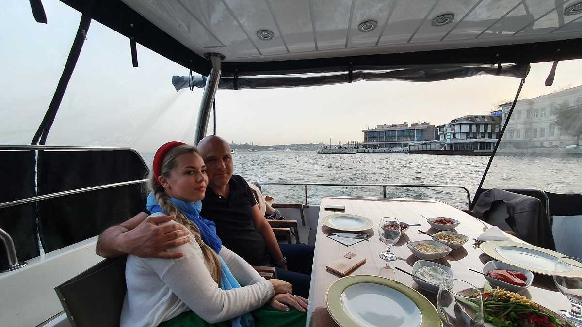 Two people having dinner on a yacht cruising in the Bosphorus Strait of Istanbul